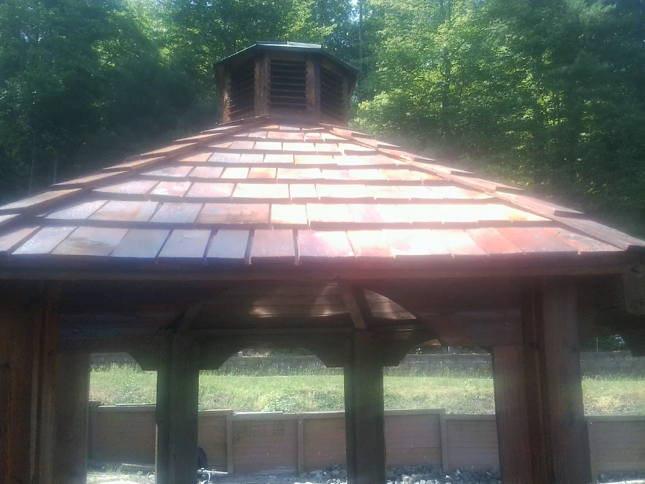 New cedar shake roof and cupola on a lakeside gazebo in Monterey